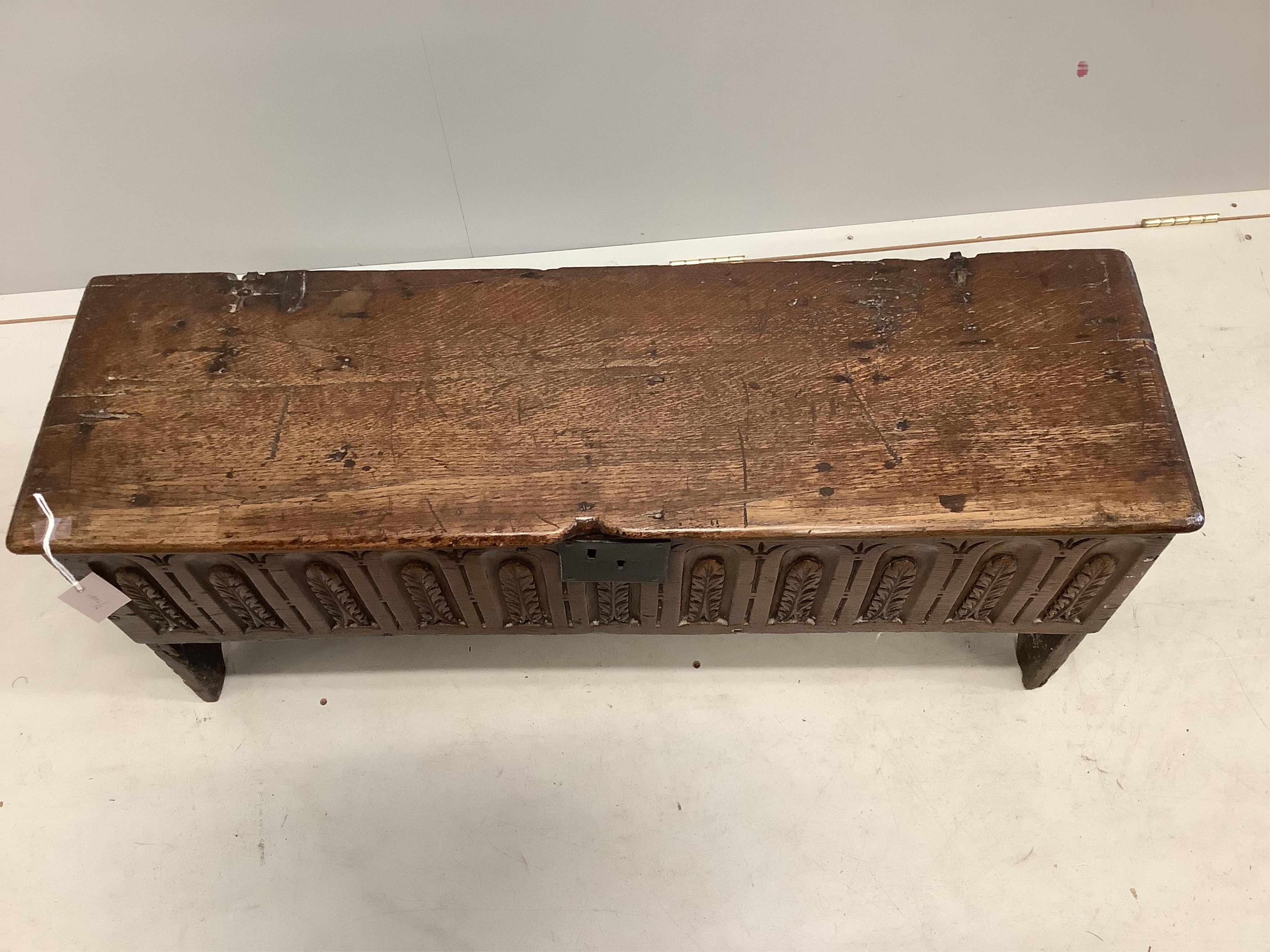 A late 17th century style carved oak six plank coffer, width 96cm, depth 29cm, height 45cm. Condition - fair